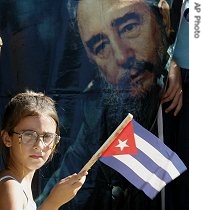 A young girl holds up a Cuban flag during an event in support of Cuban leader Fidel Castro in Havana 