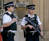 British police officers stand guard outside the Houses of Parliament in London, after Britain's national security threat level was raised to critical, Thursday August 10, 2006 