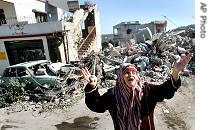Lebanese woman reacts to the destruction in the heavily-bombed town of Aita Ech Chaab, near the Israeli border