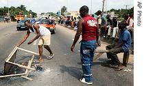 Supporters of Ivory Coast President Laurent Gbagbo block a road as part of a protest Wednesday, July 19, 2006