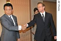 Japanese FM Taro Aso, left, shakes hanads with Acting Ambassador of Russia Mikhail Y. Galuzin prior to their meeting at his office in Tokyo Wednesday, August 16, 2006