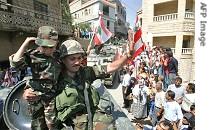 Lebanese soldier holding child, waves to civilians upon arrival in Lebanese village of Shebaa, 18 August 2006 