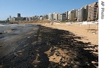 Layer of crude oil covers Ramlet el-Beida public beach in Beirut, July 28, 2006