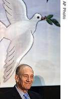 Israeli PM Ehud Olmert pauses in front of a painting of a peace dove during a visit to a school, Sunday September 3, 2006