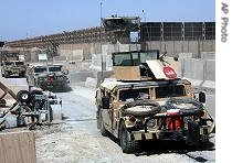 A convoy of US soldiers leave in their armored vehicles from Abu Ghraib prison, on the outskirts of Baghdad, Iraq, Saturday, September 2, 2006