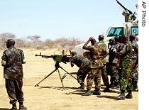 Kenyan, Zambian and Rwandan soldiers working in Darfur for AMIS take turns practicing marksman skills, June 24, 2006