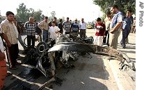 Iraqis view wreckage of a car bomb explosion in Baghdad