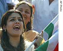 Bollywood actress Raveena Tandon holds the Indian national flag and sings the national song 'Vande mataram', in Mumbai, India, Thursday, Sept. 7, 2006