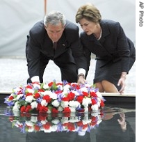 President Bush and wife, Laura, lay memorial wreath in pool of water at ground zero 