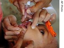 Indian health worker gives polio drops to a baby at a primary health center in Lankamura village, near the India-Bangladesh border, September 10, 2006