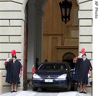 Vatican Swiss guards salute a car with an Albanian flag at Pope Benedict XVI's summer residence, September 25, 2006