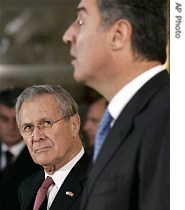 US Secretary of Defense Donald H. Rumsfeld, left, listens to Montenegrin Prime Minister Milo Djukanovic as they hold a joint news conference