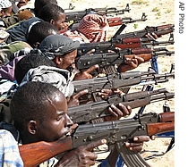 Somali people handle guns, Tuesday, September 26, 2006, at the Arbiska training camp just outside the Somali capital, Mogadishu