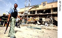 Baghdad policemen and firemen at site of a bomb explosion (file photo)