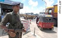 Sri Lankan soldier stands guard 11 October 2006 at main entrance to capital, Colombo