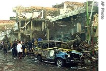 Police officers inspect the ruins of a nightclub destroyed by an explosion in Denpasar, Bali, in this Oct. 13, 2002 photo 