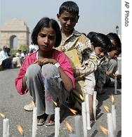 Children infected with tuberculosis light candles at a march to mark World Tuberculosis Day in New Delhi, March 24, 2006
