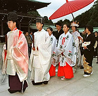 Shinto priests lead a Japanese couple to an altar at the famed Meiji Shrime in Tokyo (File photo)