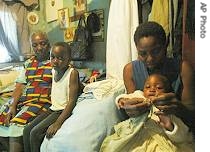 Silver Packry, right, feeds one of her children while her mother, left, looks on in Harare, October 17, 2006