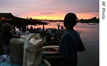 An unidentified boy sells fuel at the waterside in Yenagoa, Nigeria, Nov. 2 2006 <br />