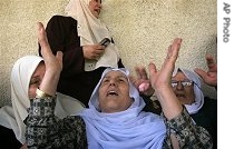 Family members mourn during the funeral procession of Mahmoud Sabah, a Hamas militant killed during an Israeli missile strike at the Jebaliya refugee camp