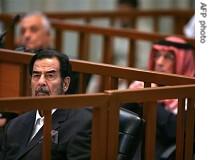 Saddam Hussein listens to testimony during his trial in Baghdad, 07 November 2006