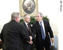 President Bush, right, shakes hands with Sen. Richard Durbin, D-Ill., left, as Democratic Senate leader Sen. Harry Reid of Nev. looks on