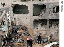 Palestinians inspect rubble of building after it was hit by Israeli warplane in Gaza City, Nov. 14, 2006