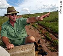 Peter Bowen, 42, a white farmer from Zimbabwe, points to his potato cultivations (File photo) 