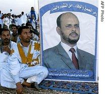 Supporters stand by a poster of Islamist Moderate Party candidate Jamil Mansour during a late meeting, in Nouakchott, November, 17 2006