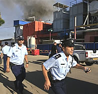 Israeli police officers run at the scene of a rocket attack by Palestinian militants in the Gaza Strip hit a factory in the town of Sderot, Israel, Tuesday, November 21, 2006
