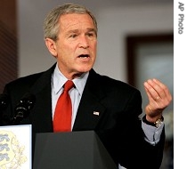 President George W. Bush gestures during a press conference with Estonian President Toomas Hendrik Ilves, not seen, 28 Nov. 2006