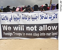 Somali women demonstrators hold a banner during a rally to protest the presence of Ethiopian troops in Mogadishu Somalia, 28 Nov 2006