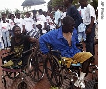 Two war victims are seen in wheelchairs at the launch of Liberia's Truth and Reconciliation Commission in the city of Monrovia, Liberia, June 22, 2006