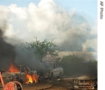 Cars burn after a bomb exploded at a check point in Baidoa, Somalia