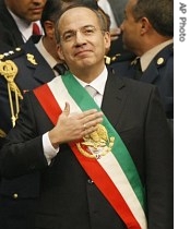 Mexican President Felipe Calderon touches his heart after being sworn in at the National Congress during his inauguration ceremony