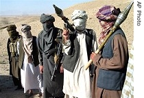 Militants who they say are Talebans, pose with RPG and AK47, in Zabul province, south of Kabul