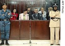 Libyan security guards stand in front of the dock during the trial of five Bulgarian nurses and a Palestinian doctor, in Tripoli, 04 Nov 2006
