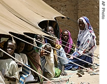 Sudanese refugee children sit in their makeshift classroom, Wednesday, April 19, 2006 in the refugee camp Kou Kou Angarana in Chad some 30 kilometers from the Sudan border