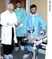 Iran's President Mahmoud Ahmadinejad, right, and President of Atomic Energy Organization of Iran, Reza Aghazadeh, left, visit Natanz uranium enrichment facilities, 15 Feb 2006<br />