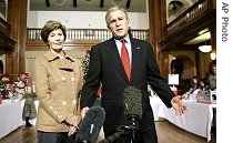 President Bush, accompanied by first lady Laura Bush, addresses the media about his visit with wounded troops at Walter Reed Army Medical Center