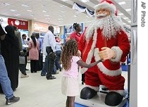 A child plays with a Santa Claus display model at a shopping mall in Nairobi, 21 Dec. 2006