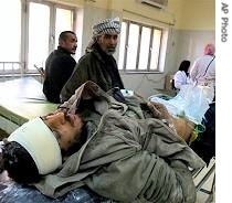 Iraqi man injured in a roadside bomb blast lies in a bed in Baghdad's Kindi hospital, 24 Dec 2006