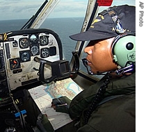 A crew of an Indonesian Navy surveillance plane talks on the radio during a search mission for the missing Adam Air jetliner over Sulawesi island, Indonesia, 03 Jan 2007