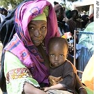 Woman and child take part in a discussion at a village meeting in village of Bandiagara, Mali (File photo)