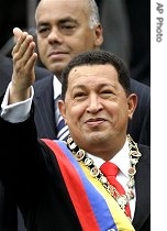 Hugo Chavez gestures to supporters as his Vice-President Jorge Rodriguez stands behind during the inauguration ceremony, 10 Jan. 07