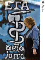 Female resident walks in front of graffiti from the Basque separatist group ETA in Alsasua, Spain, 9 Jan 2007