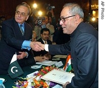Indian External Affairs Minister Pranab Mukherjee, right, shakes hands with his Pakistani counterpart Khursheed Kasuri