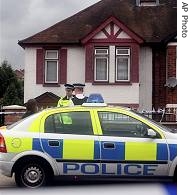 Police officers stand outside a semi-detached house in High Wycombe, England, after a anti-terror raid (File photo) 