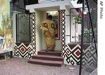 Congolese woman withdraws money at the first 24-hour cash machine operated by ProCredit Bank, in Kinshasa, Aug 2006
